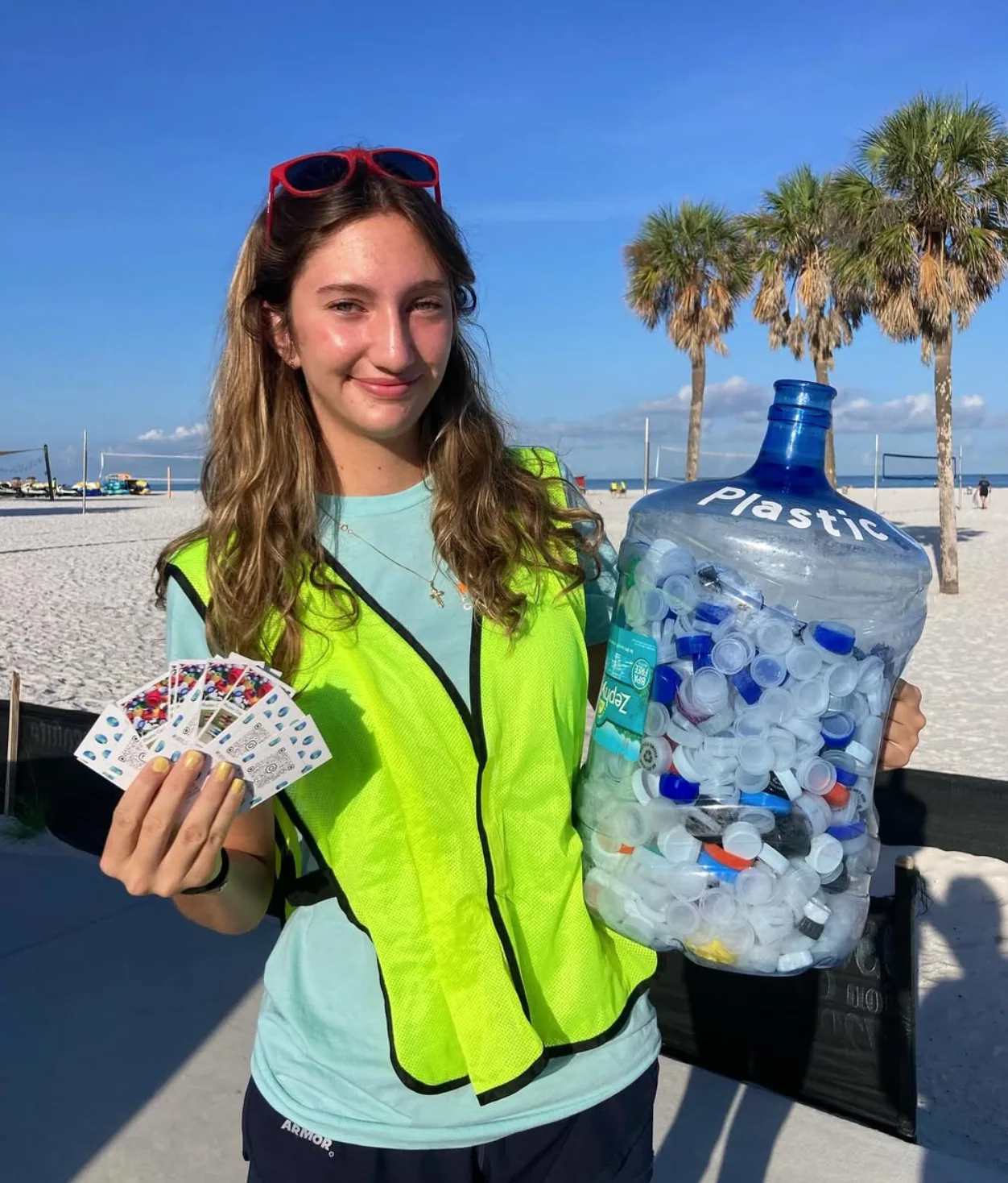 Marissa collecting plastic caps near the beach